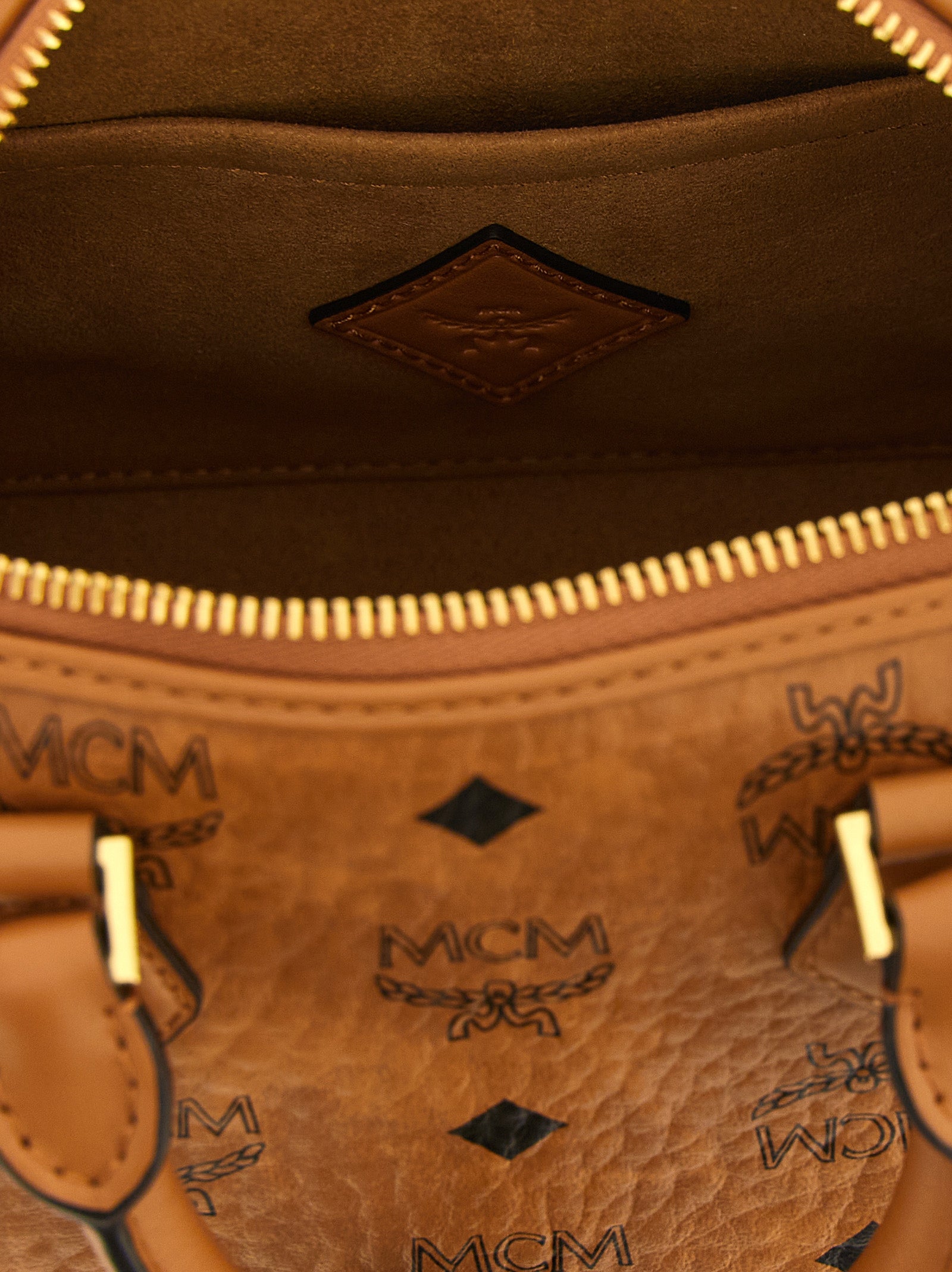 Travel Belt Pouch Handbag by MCM for women in polyester polyethylene polyurethane leather brown, gold & monogram features a contemporary silhouette, showcasing a secure , ample , and contemporary shoulder-strap, adjustable-strap, detachable-strap & handle for a sophisticated look.