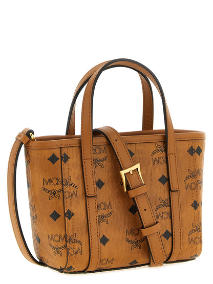 Mini Shopper Tote Bag by MCM for women in cotton canvas poly leather brown, gold, natural & monogram features an sumptuous Visetos Cotton Canvas Poly Leather Mini Shopper Tote Bag design with a secure , ample , and versatile shoulder-strap & handle for an sumptuous finish.