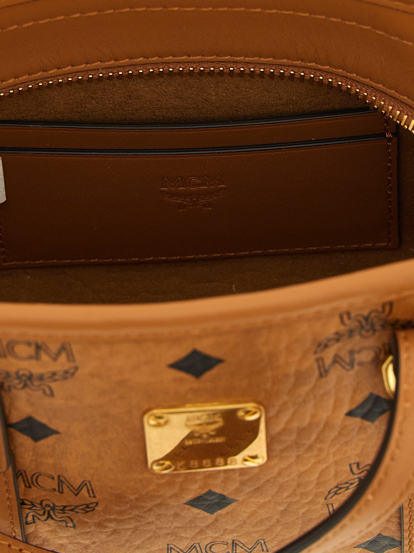 Mini Shopper Tote Bag by MCM for women in cotton canvas poly leather brown, gold, natural & monogram features a distinguished Visetos Cotton Canvas Poly Leather Mini Shopper Tote Bag design, complete with a secure , ample , and versatile shoulder-strap & handle for a distinguished look.