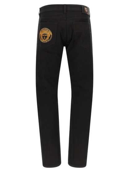 Jeans by Versace for men in stretch denim cotton black & gold features a polished silhouette with a polished straight-leg, reaching a polished long and finished with a polished .