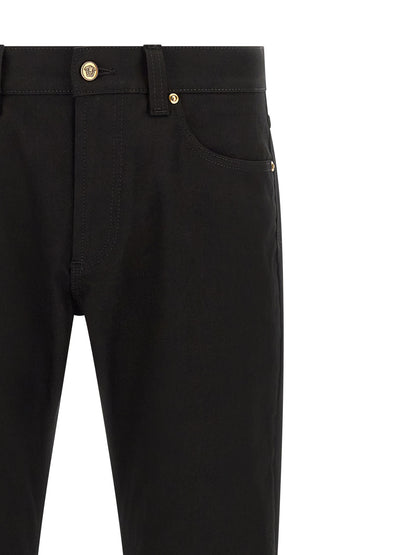 Jeans by Versace for men in stretch denim cotton black & gold presents a refined pantology silhouette, artfully defined by a refined pantology straight-leg, long, and a sophisticated .