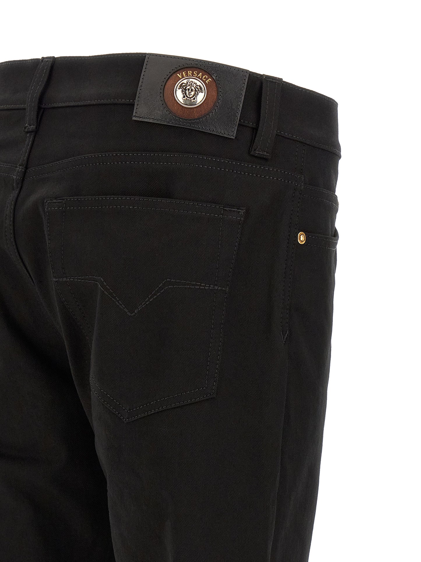 Jeans by Versace for men in stretch denim cotton black & gold presents a tailored silhouette, showcasing a tailored straight-leg and long cut with a refined for a truly tailored aesthetic.