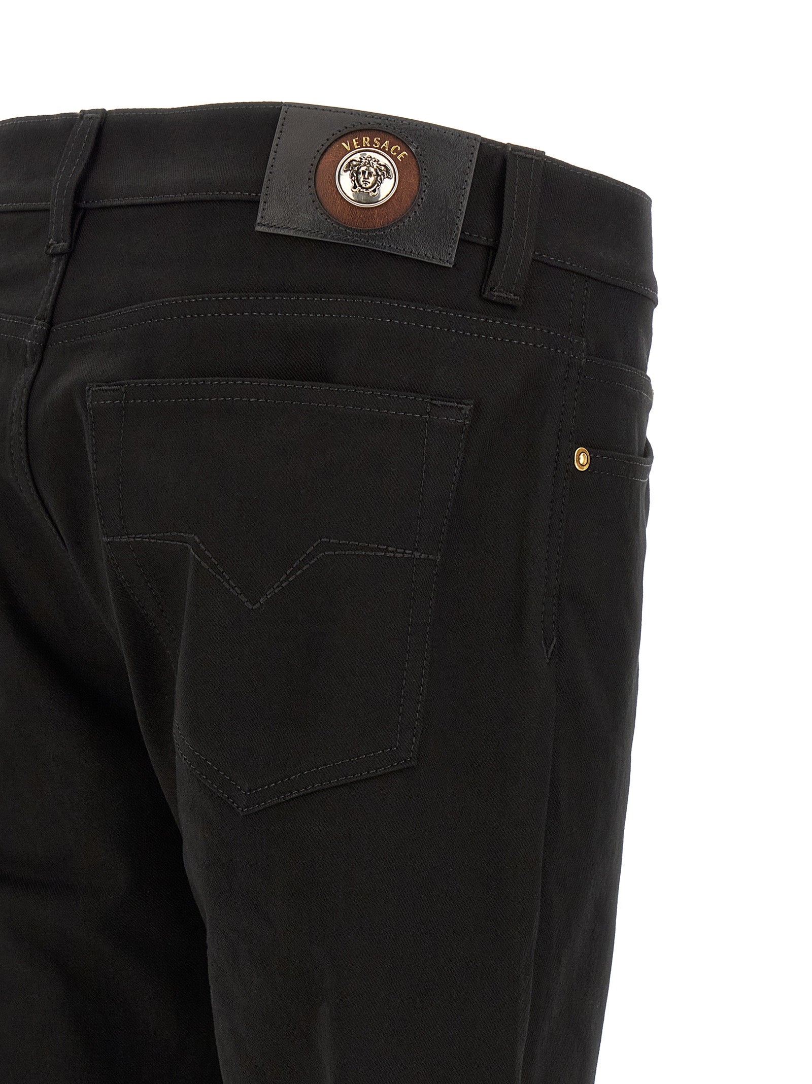 Jeans by Versace for men in stretch denim cotton black & gold presents a tailored silhouette, showcasing a tailored straight-leg and long cut with a refined for a truly tailored aesthetic.