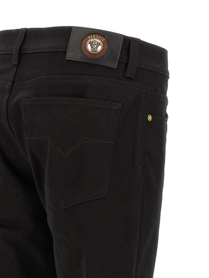 Jeans by Versace for men in stretch denim cotton black & gold presents a tailored silhouette, showcasing a tailored straight-leg and long cut with a refined for a truly tailored aesthetic.