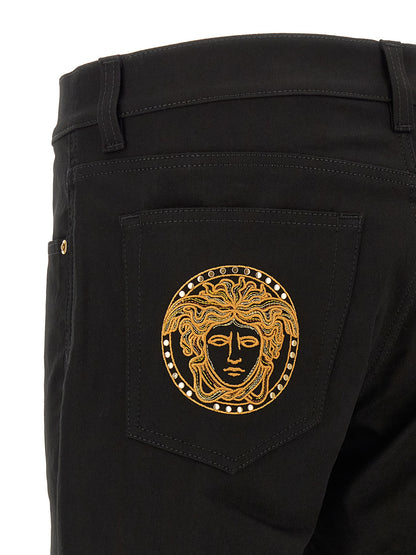 Jeans by Versace for men in stretch denim cotton black & gold features an sartorial straight-leg and long with a cut for a sartorial finish.