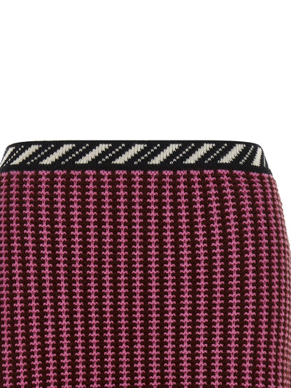Skirt by Versace for women in virgin wool black, burgundy, cream, gold, multicolor, pink, patterned, signature & striped showcases a sultry silhouette, elegantly defined by its mini long and the sophisticated sultry design of the Crochet Medusa Women's Virgin Wool Mini Long Skirt.