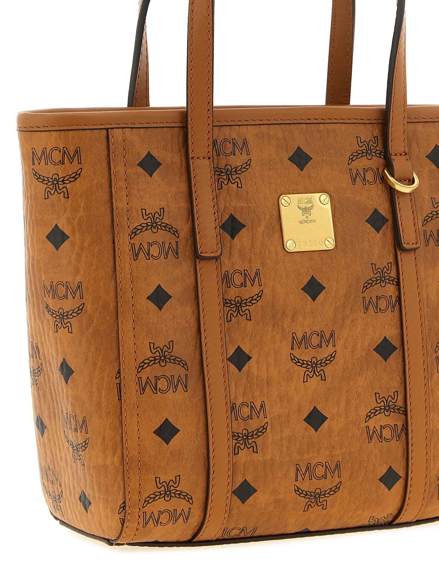 Small Shopper Tote Bag by MCM for women in polyester polyethylene polyurethane leather brown, gold, signature & monogram features a distinguished Visetos Polyester Polyethylene Polyurethane Leather Small Shopper Tote Bag design, complete with a secure zipper, ample , and versatile shoulder-strap, handle & adjustable-strap for a distinguished look.