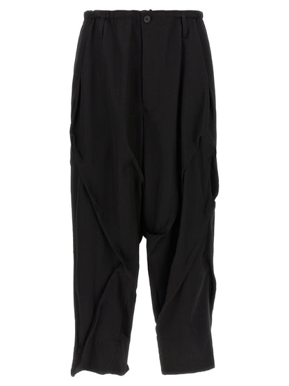 Casual Pants by Yohji Yamamoto for men in wool black presents a tailored silhouette, showcasing a tailored wide and long cut with a refined for a truly tailored aesthetic.