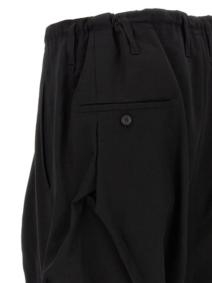 Casual Pants by Yohji Yamamoto for men in wool black features an refined tailoring silhouette, showcasing a premium wide with a and long cut for a refined tailoring look.