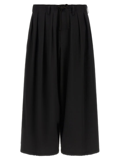 Trousers by Yohji Yamamoto for men in wool black presents a smart silhouette, meticulously detailed with a smart wide, a smart long, and a smart .