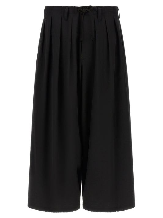 Trousers by Yohji Yamamoto for men in wool black presents a smart silhouette, meticulously detailed with a smart wide, a smart long, and a smart .