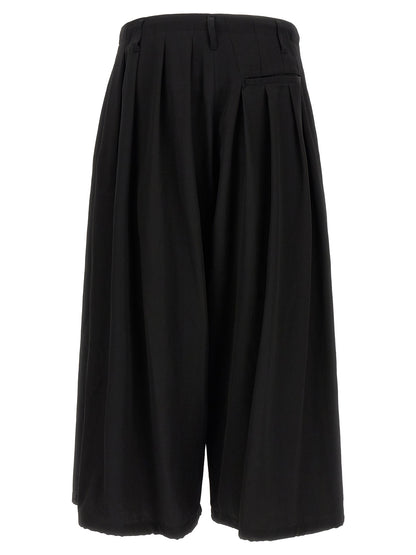 Trousers by Yohji Yamamoto for men in wool black features an on trend silhouette, showcasing a sophisticated wide with a long and for an on trend finish.