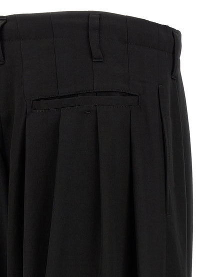 Trousers by Yohji Yamamoto for men in wool black features a artisanal silhouette, showcasing a sophisticated wide with a long and for a artisanal finish.