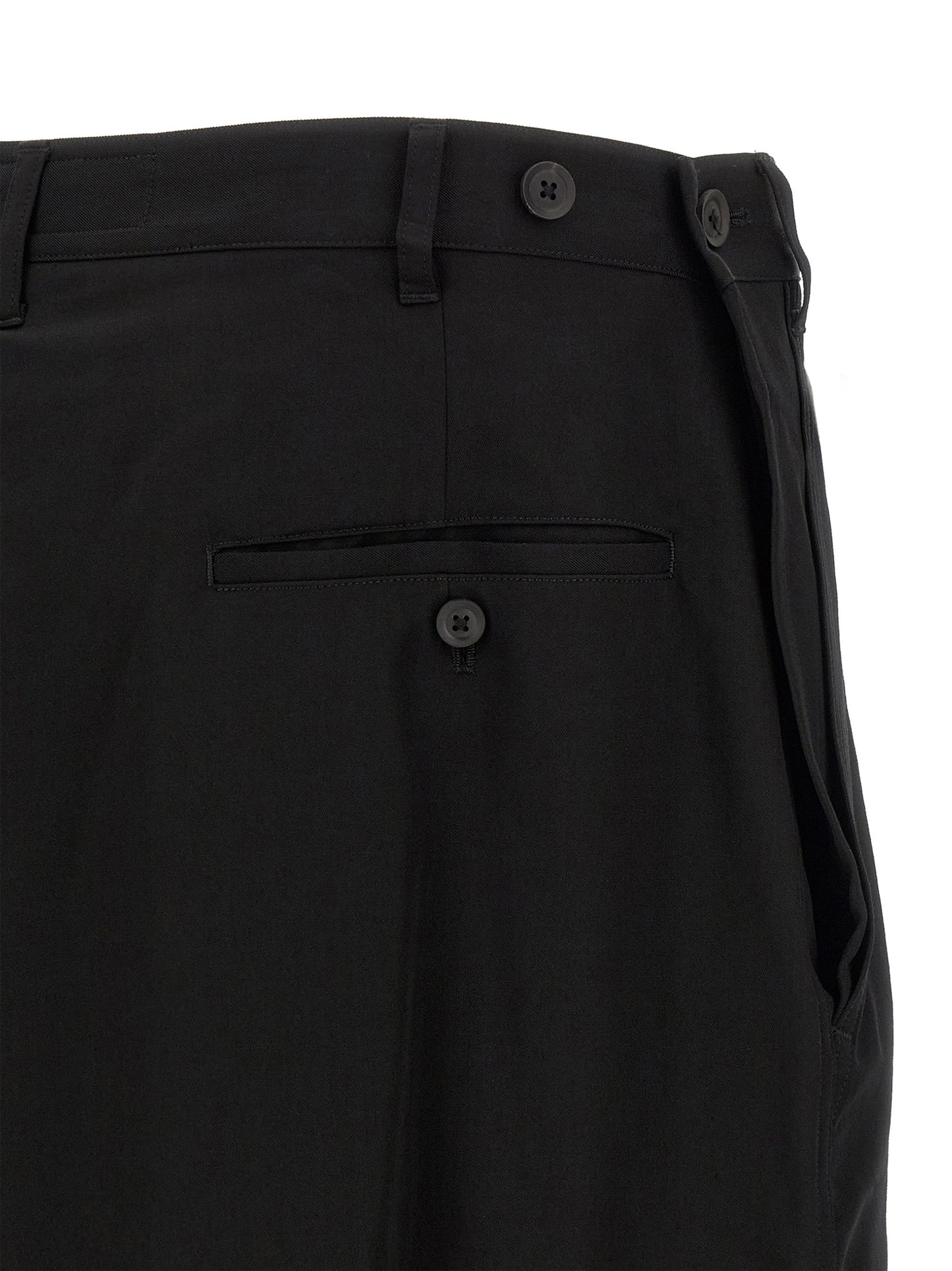 Trousers by Yohji Yamamoto for men in wool black presents a perennial silhouette, meticulously tailored with a wide cut, long finish, and an elegant .