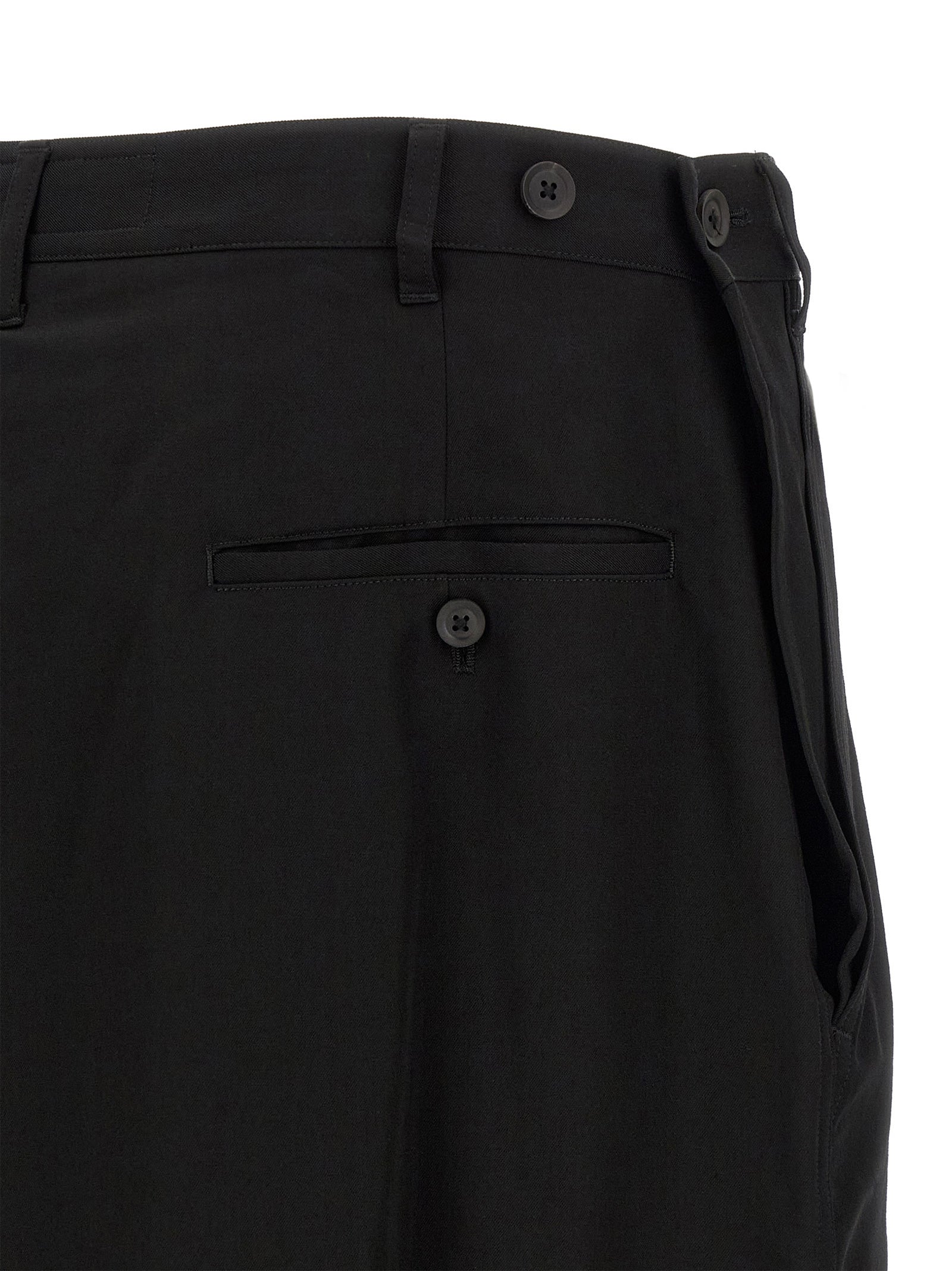 Trousers by Yohji Yamamoto for men in wool black presents a perennial silhouette, meticulously tailored with a wide cut, long finish, and an elegant .