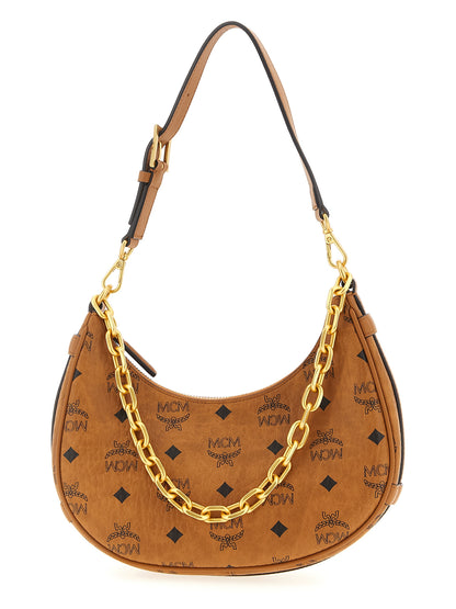 Mini Evening Crescent Shoulder Bag by MCM for women in poly cotton canvas brown & monogram features a enviable silhouette, showcasing a secure zipper, ample , and enviable shoulder-strap, adjustable-strap & handle for a enviable finish.