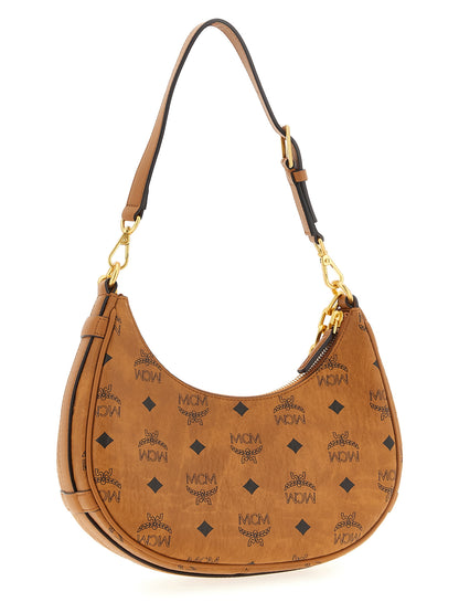 Mini Evening Crescent Shoulder Bag by MCM for women in poly cotton canvas brown & monogram features a effortless chic silhouette with a secure zipper, ample , and versatile shoulder-strap, adjustable-strap & handle for a effortless chic finish.
