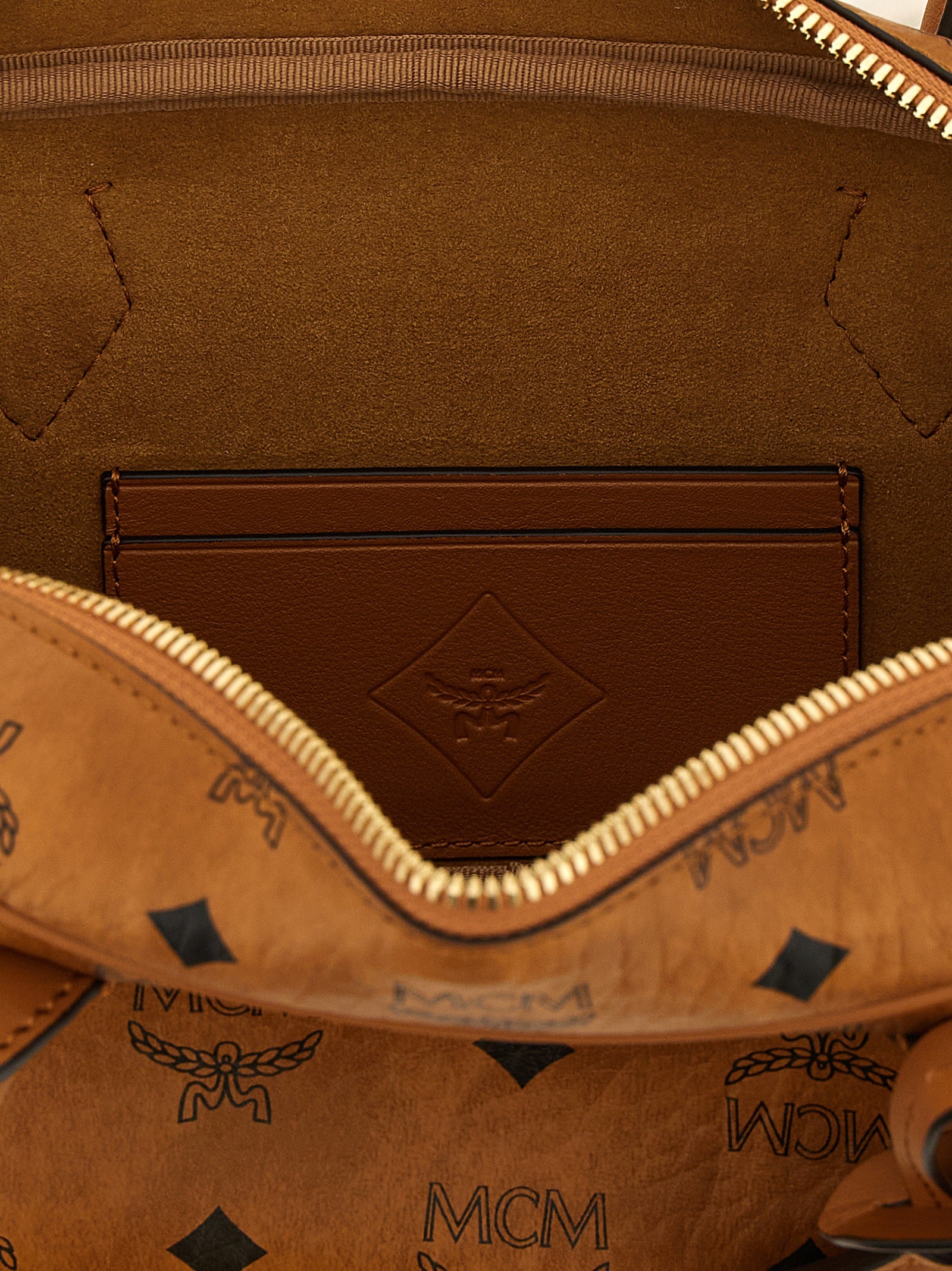 East West Shoulder Bag by MCM for women in suede polyester polyethylene polyurethane leather brown & natural features an effortlessly chic silhouette with a secure zipper, ample , and versatile shoulder-strap for effortlessly chic everyday luxury.