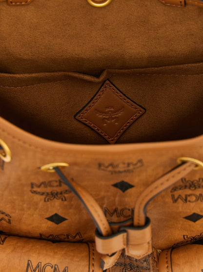 Medium Drawstring Backpack by MCM for women in polyester polyethylene polyurethane leather brown, gold & monogram features a utilitarian chic Aren Visetos Polyester Polyethylene Polyurethane Leather Medium Drawstring Backpack design with a secure flap & drawstring, ample , and versatile shoulder-strap, backpack-strap & adjustable-strap for a utilitarian chic finish.