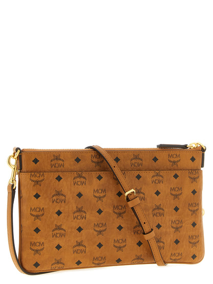 Mini Clutch Handbag by MCM for women in polyester polyethylene polyurethane leather brown, gold & monogram features an sculptural silhouette, showcasing a secure zipper and sculptural with versatile shoulder-strap & adjustable-strap for a sophisticated look.