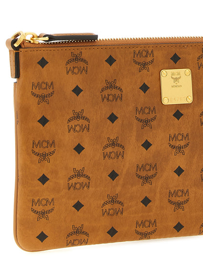 Mini Clutch Handbag by MCM for women in polyester polyethylene polyurethane leather brown, gold & monogram features a statuesque silhouette, showcasing a secure zipper and organized with versatile shoulder-strap & adjustable-strap for statuesque evening wear.