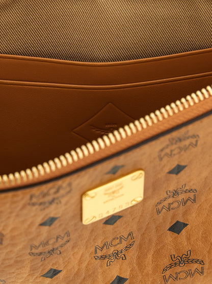 Mini Clutch Handbag by MCM for women in polyester polyethylene polyurethane leather brown, gold & monogram features a architectural silhouette, showcasing a secure zipper, ample , and versatile shoulder-strap & adjustable-strap for a architectural finish.