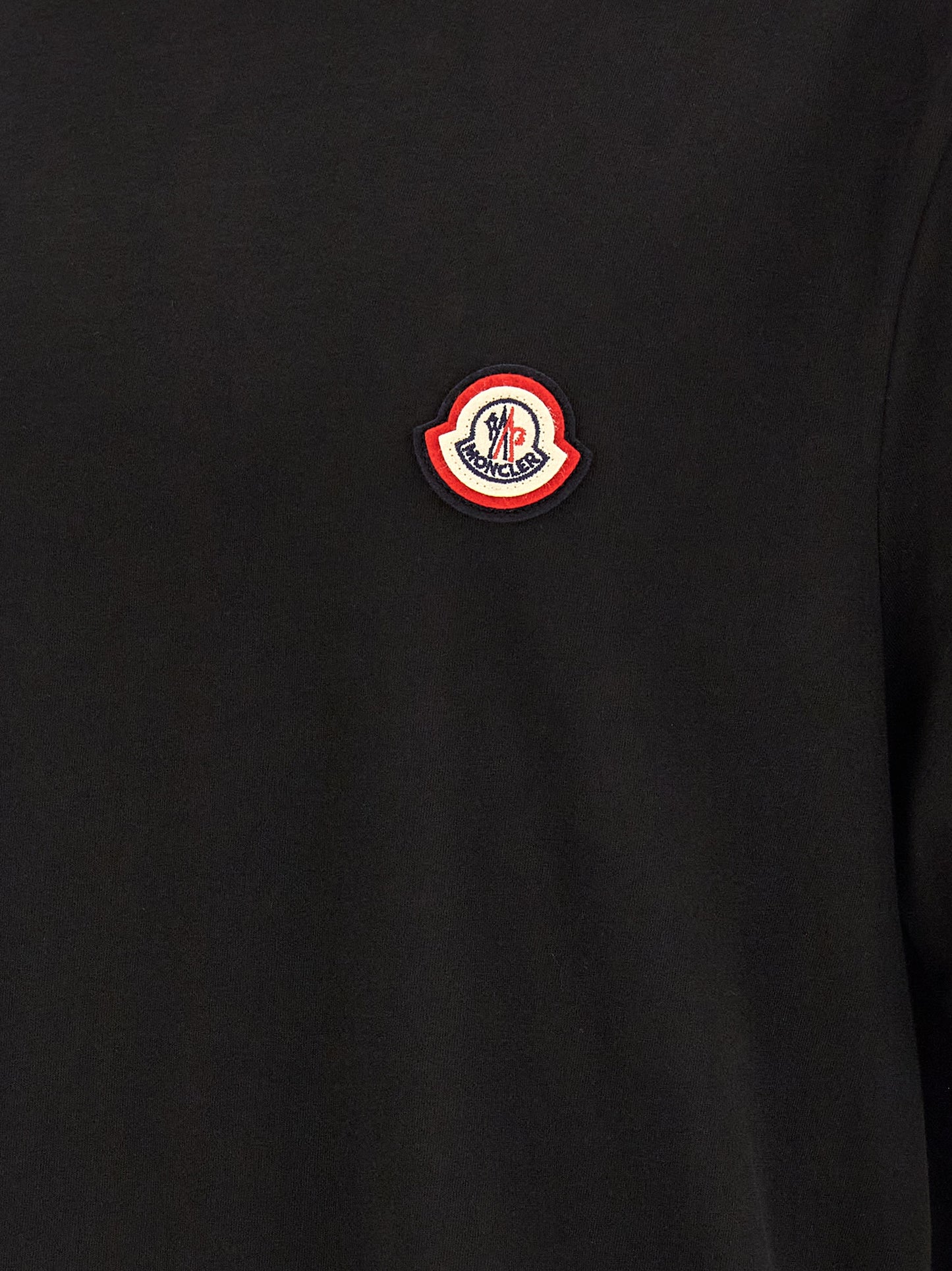T-Shirt by Moncler for men in cotton black showcases a unassuming silhouette, artfully detailed with a refined and unassuming for a sophisticated, contemporary look.