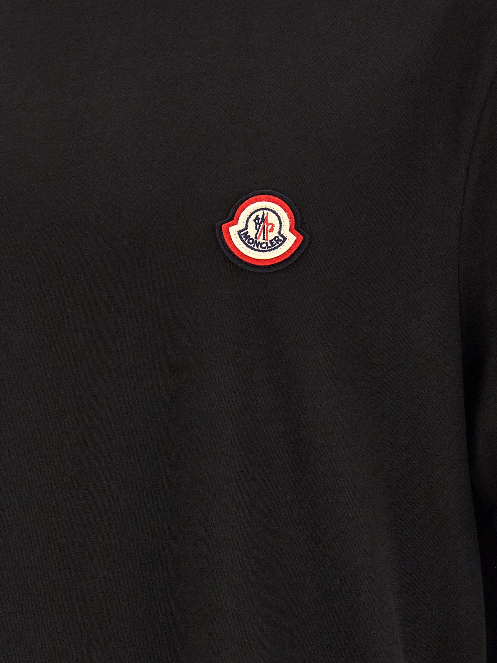 T-Shirt by Moncler for men in cotton black showcases a unassuming silhouette, artfully detailed with a refined and unassuming for a sophisticated, contemporary look.