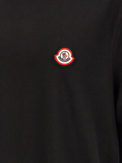 T-Shirt by Moncler for men in cotton black showcases a unassuming silhouette, artfully detailed with a refined and unassuming for a sophisticated, contemporary look.