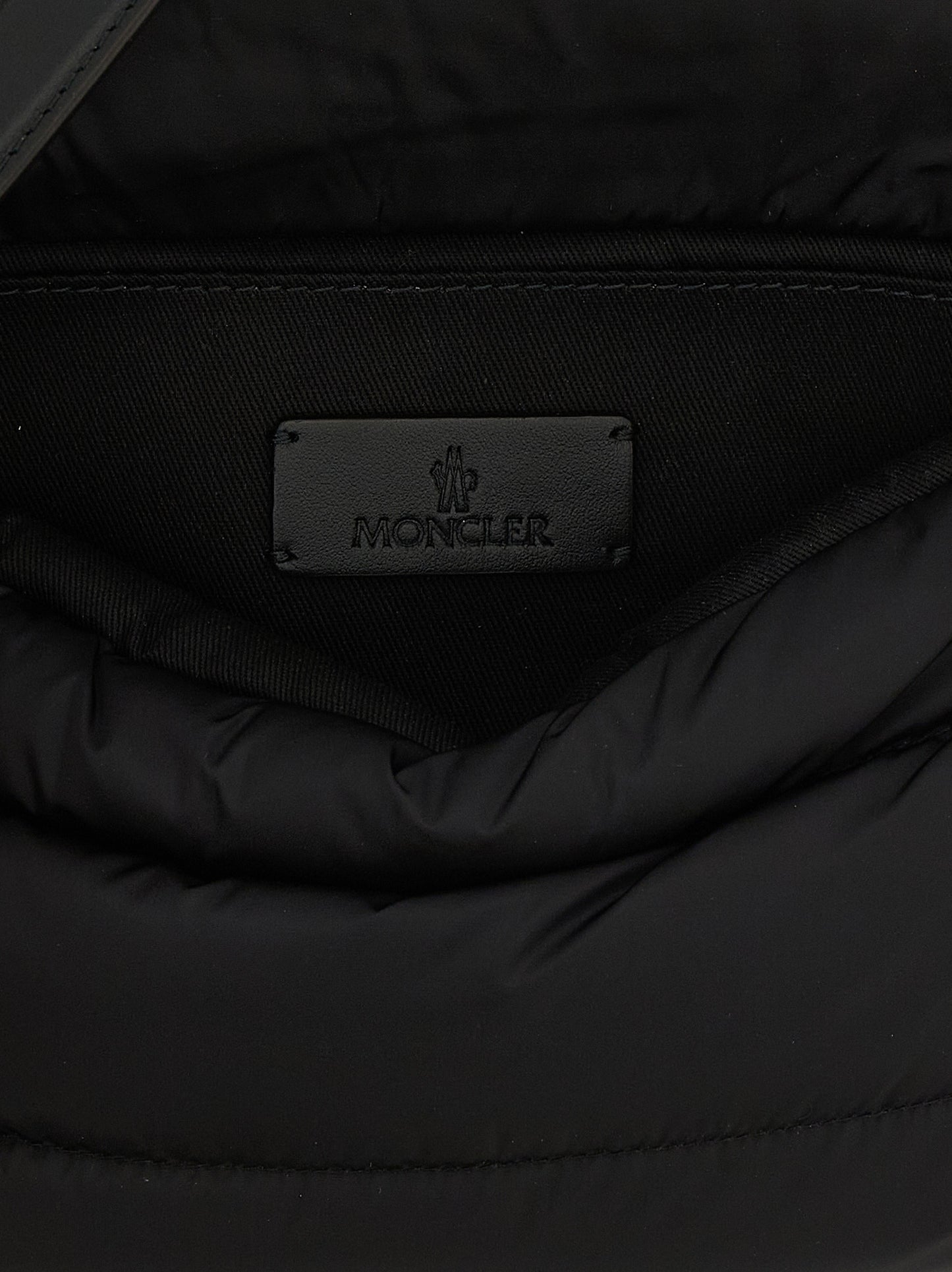 Mini Shoulder Flap Bag by Moncler for women in polyamide leather black, silver & signature features a enviable silhouette, showcasing a secure flap, magnetic & buckle, ample , and enviable shoulder-strap, adjustable-strap & handle for a enviable finish.
