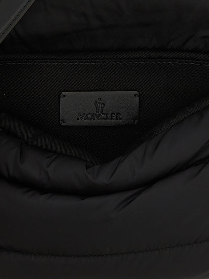 Mini Shoulder Flap Bag by Moncler for women in polyamide leather black, silver & signature features a enviable silhouette, showcasing a secure flap, magnetic & buckle, ample , and enviable shoulder-strap, adjustable-strap & handle for a enviable finish.
