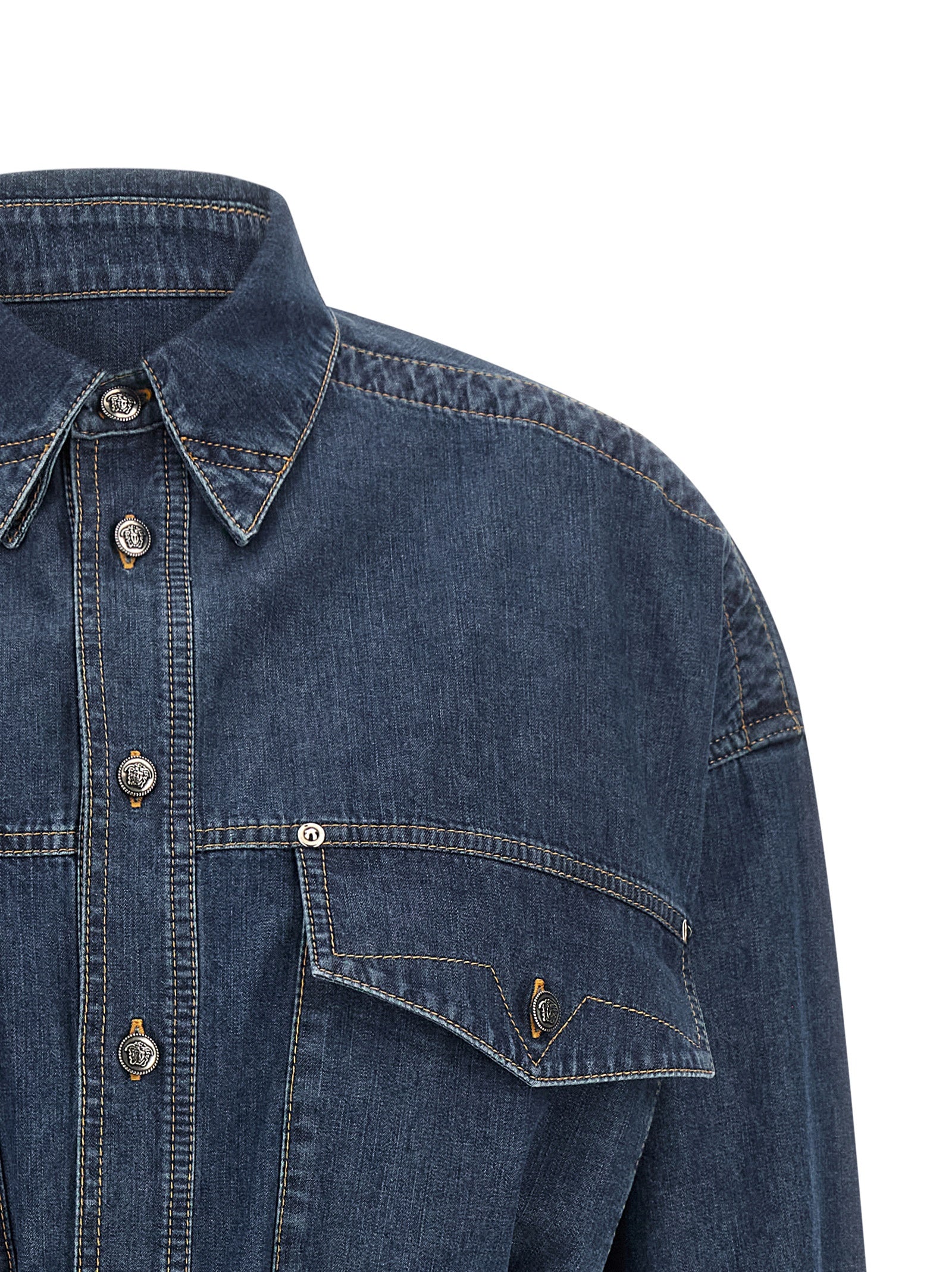 Dress by Versace for women in denim cotton blue features an eye catching silhouette with a sophisticated , elegant , and a refined short mini for a eye catching aesthetic.