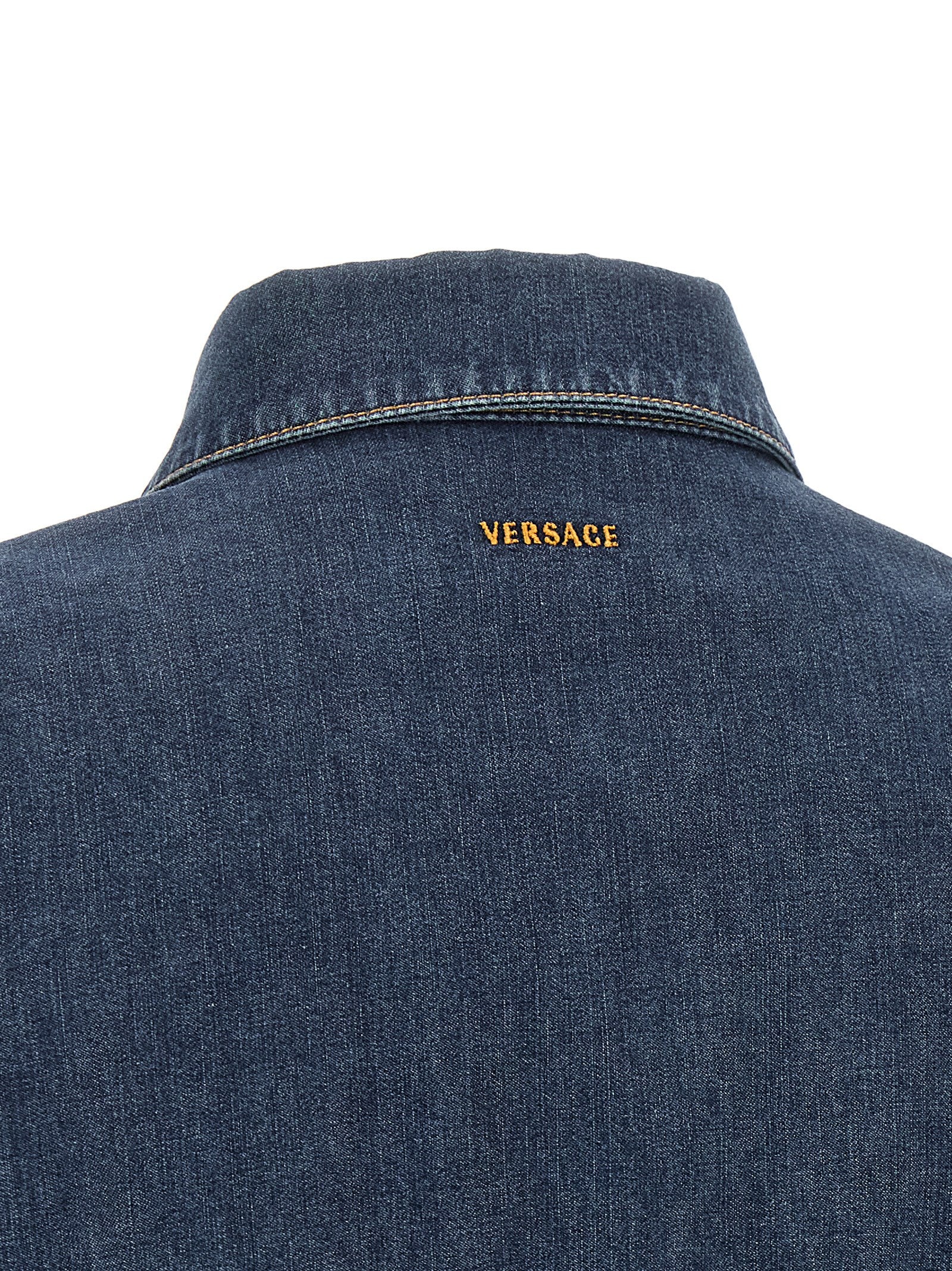Dress by Versace for women in denim cotton blue showcases a striking silhouette, elegantly detailed with a , refined , and a striking short mini for a striking finish.