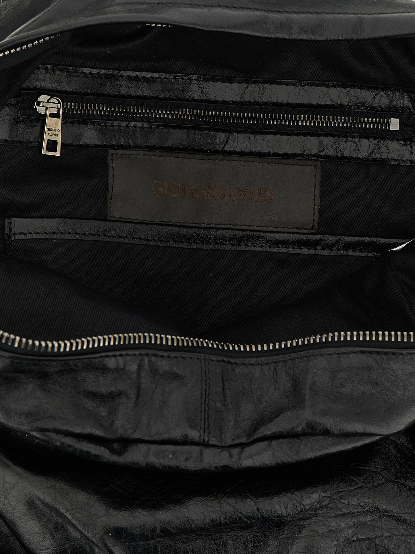 Backpack by GIORGIO BRATO for men in lambskin leather black & natural features a utilitarian chic Lambskin Leather Backpack design with a secure zipper, ample external-pockets, and versatile handle, backpack-strap & adjustable-strap for a utilitarian chic finish.