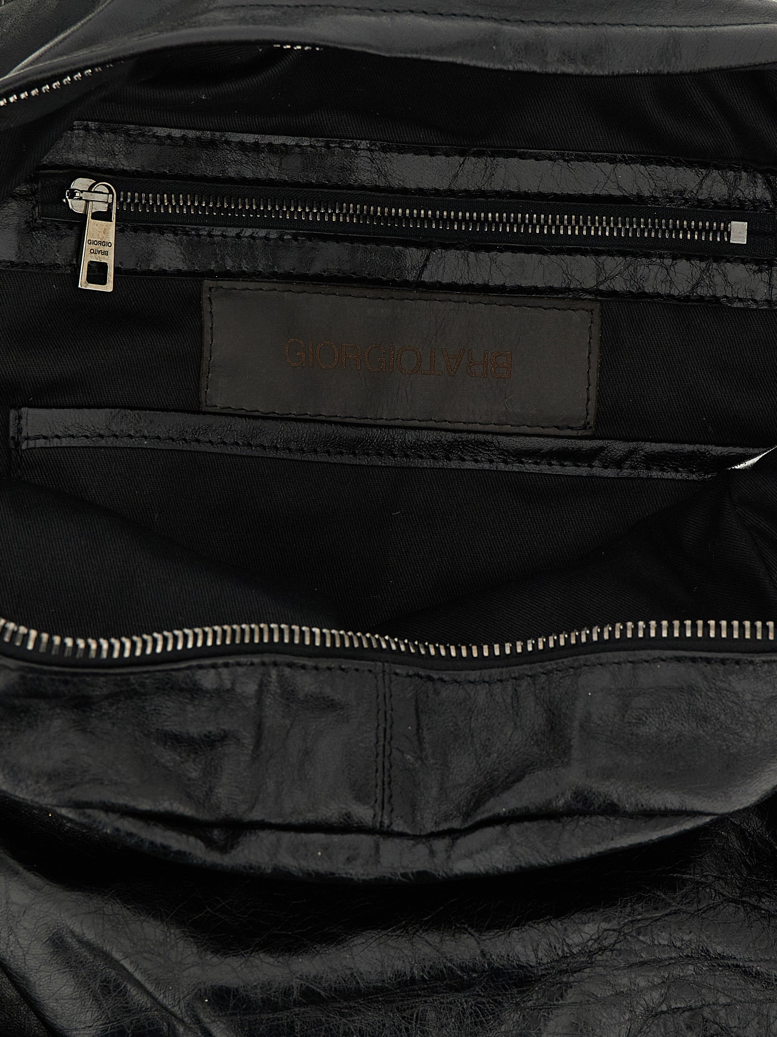 Backpack by GIORGIO BRATO for men in lambskin leather black & natural features a utilitarian chic Lambskin Leather Backpack design with a secure zipper, ample external-pockets, and versatile handle, backpack-strap & adjustable-strap for a utilitarian chic finish.