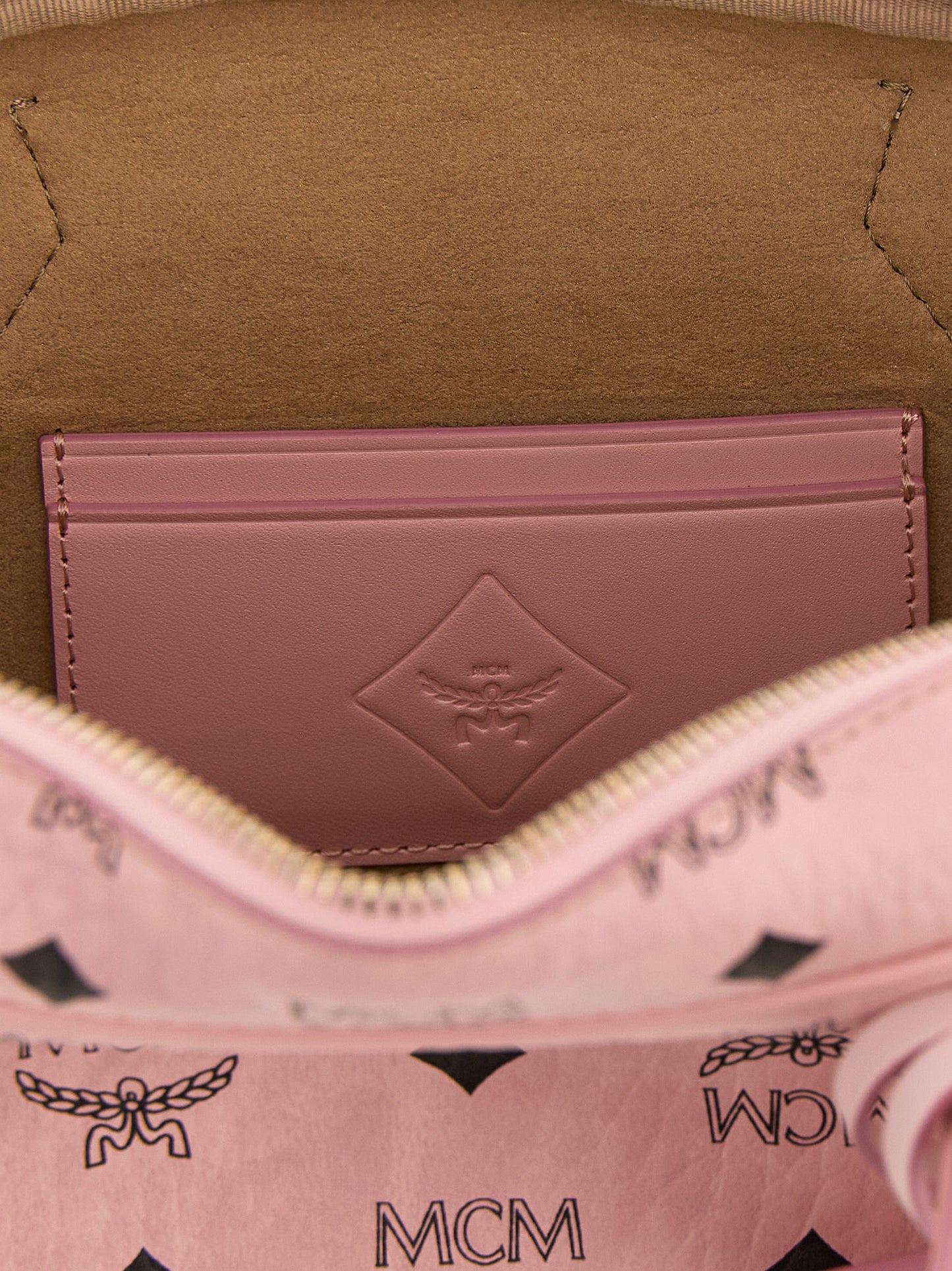 East West Shoulder Bag by MCM for women in suede polyethylene leather & coated canvas gold, multicolor, pink, patterned & monogram features an effortlessly chic silhouette with a secure zipper, ample cardholder, and versatile shoulder-strap, detachable-strap & handle for effortlessly chic everyday luxury.