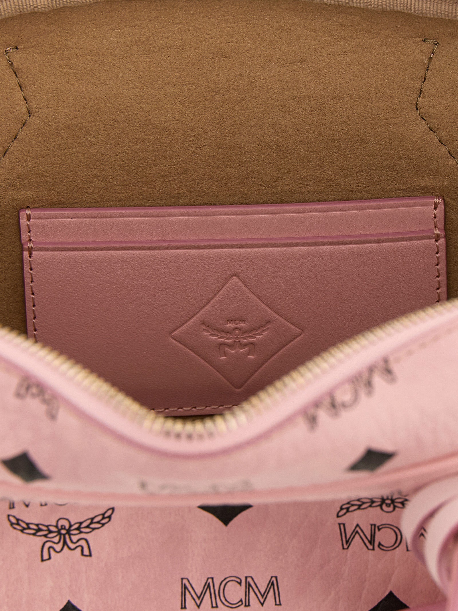 East West Shoulder Bag by MCM for women in suede polyethylene leather & coated canvas gold, multicolor, pink, patterned & monogram features an effortlessly chic silhouette with a secure zipper, ample cardholder, and versatile shoulder-strap, detachable-strap & handle for effortlessly chic everyday luxury.