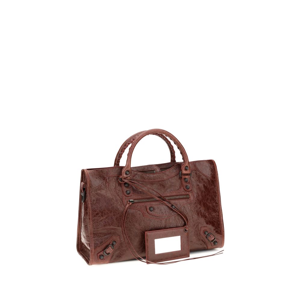 Medium Handbag by Balenciaga for women in leather bordeaux features an refined silhouette, showcasing a secure zipper, ample , and versatile shoulder-strap, adjustable-strap & handle for a sophisticated refined aesthetic.