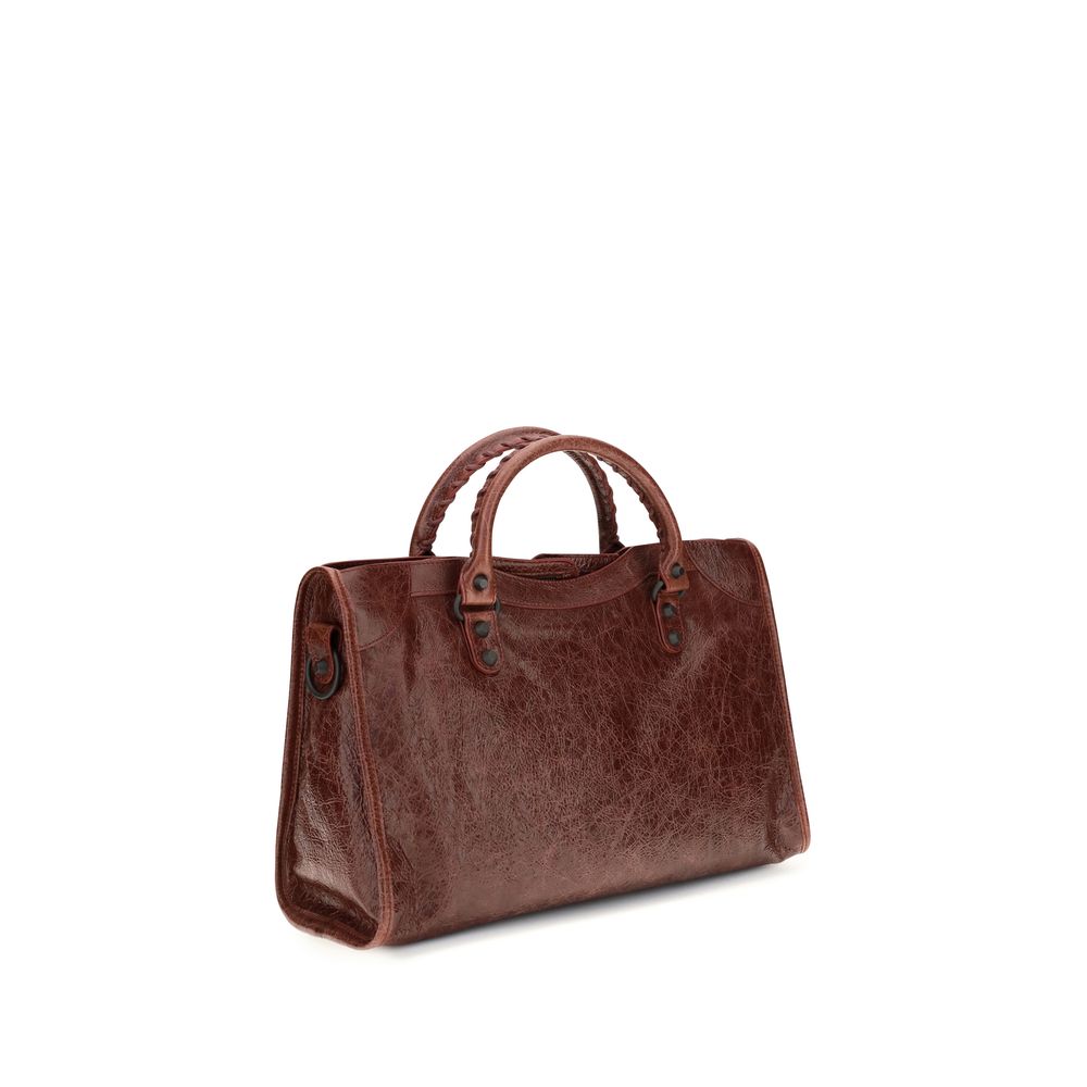 Medium Handbag by Balenciaga for women in leather bordeaux features a signature silhouette, showcasing a secure zipper and signature with versatile shoulder-strap, adjustable-strap & handle for a sophisticated look.