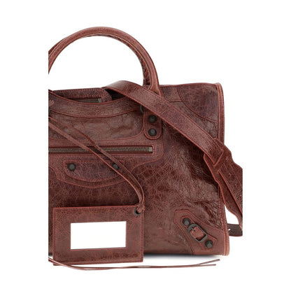 This Medium Handbag by Balenciaga for women in leather and bordeaux presents a sculptural silhouette featuring a secure zipper, ample , and versatile shoulder-strap, adjustable-strap & handle for a sculptural finish.