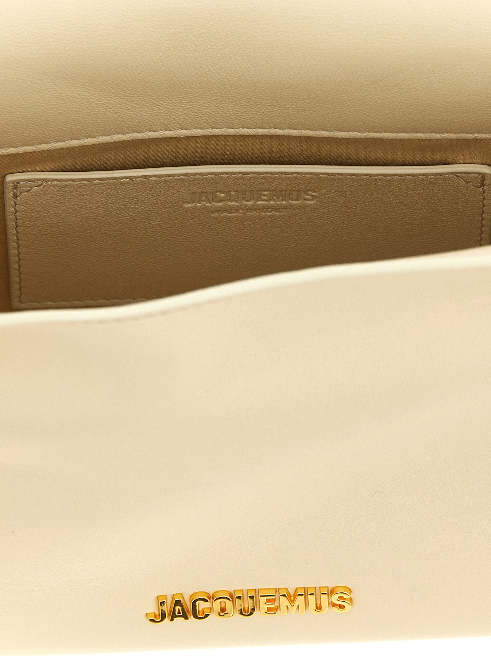 Pouch Clutch Handbag by Jacquemus for women in nappa lamb leather & cotton gold, ivory, natural & white features a statuesque silhouette, showcasing a secure magnetic and organized with versatile shoulder-strap & adjustable-strap for statuesque evening wear.