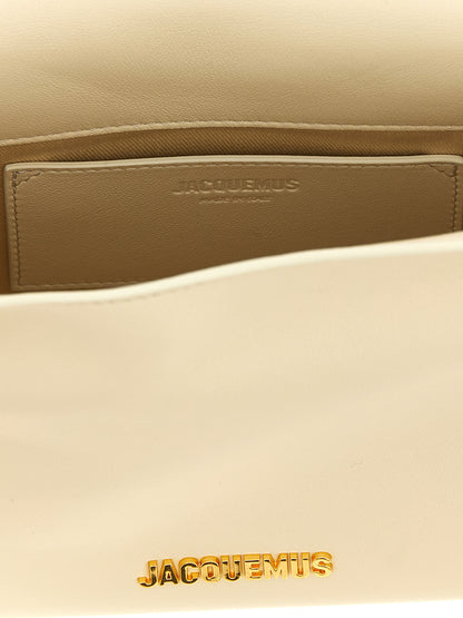 Pouch Clutch Handbag by Jacquemus for women in nappa lamb leather & cotton gold, ivory, natural & white features a statuesque silhouette, showcasing a secure magnetic and organized with versatile shoulder-strap & adjustable-strap for statuesque evening wear.