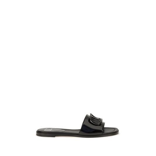 Flat Slider Sandals by Valentino Garavani for women in bos taurus calf patent leather black features an exquisite silhouette, showcasing the exquisite V Logo Women's Bos Taurus Calf Patent Leather Flat Slider Sandals with a flat and open toe style.