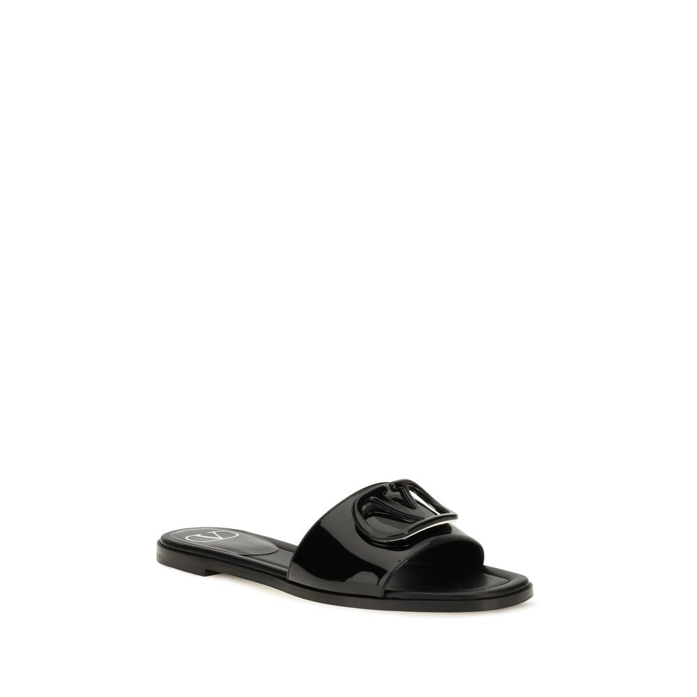 Flat Slider Sandals by Valentino Garavani for women in bos taurus calf patent leather black features an effortlessly chic silhouette from the V Logo Women's Bos Taurus Calf Patent Leather Flat Slider Sandals collection, showcasing a effortlessly chic flat and elegant open toe style.