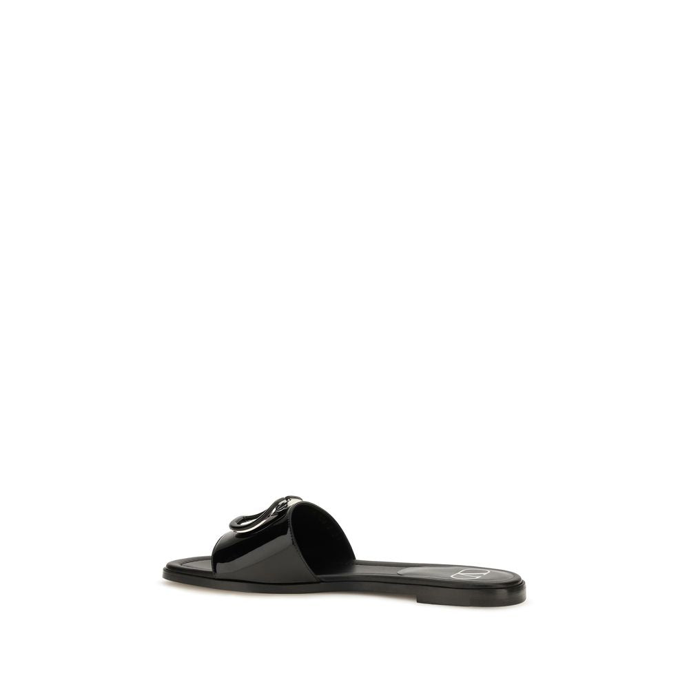 Flat Slider Sandals by Valentino Garavani for women in bos taurus calf patent leather and black presents a captivating silhouette, showcasing the signature style of the V Logo Women's Bos Taurus Calf Patent Leather Flat Slider Sandals with a captivating flat and captivating open toe style.