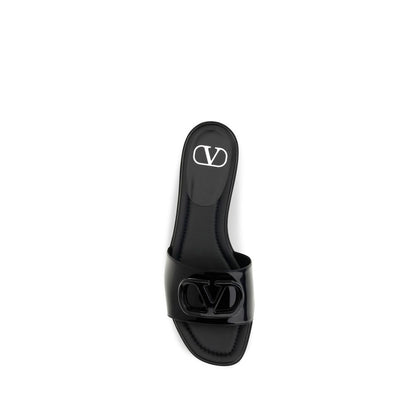 Flat Slider Sandals by Valentino Garavani for women in bos taurus calf patent leather black features an statuesque V Logo Women's Bos Taurus Calf Patent Leather Flat Slider Sandals silhouette with a refined flat and elegant open toe style.