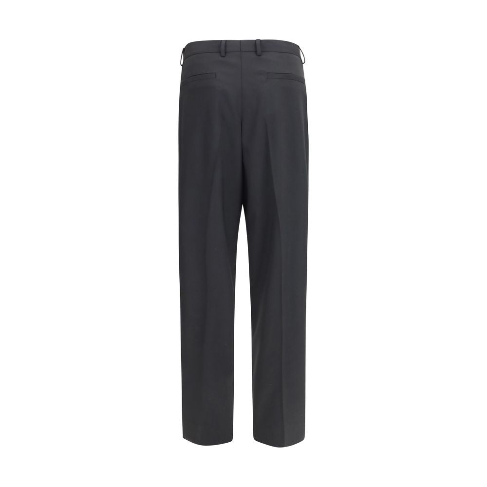 Trousers by Dolce & Gabbana for men in wool black presents a perennial silhouette, meticulously tailored with a regular-fit & wide cut, long finish, and an elegant .