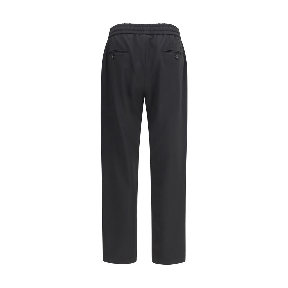 Joggers by Dolce & Gabbana for men in virgin wool black presents a tailored silhouette, showcasing a tailored regular-fit and long cut with a refined for a truly tailored aesthetic.