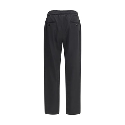 Joggers by Dolce & Gabbana for men in virgin wool black presents a tailored silhouette, showcasing a tailored regular-fit and long cut with a refined for a truly tailored aesthetic.