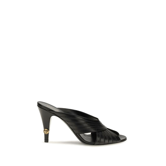 Mules Flat Shoes by Versace for women in nappa leather black presents a effortless chic silhouette, showcasing the Medusa Women's Nappa Leather Mules Flat Shoes design with a effortless chic and open toe style for a sophisticated look.